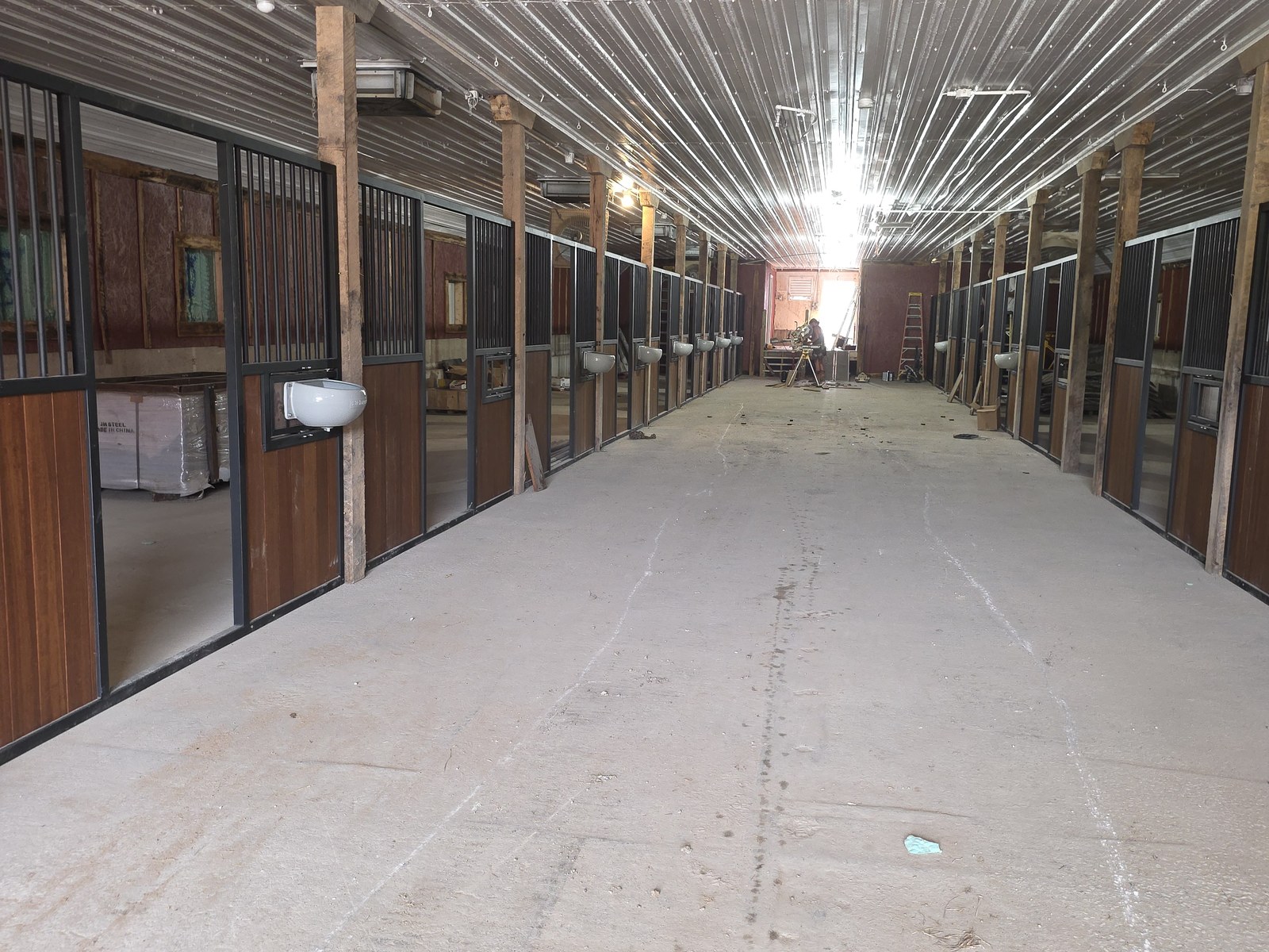 Aisle view of climate-friendly barn stalls at BV Farms in Defiance, Missouri